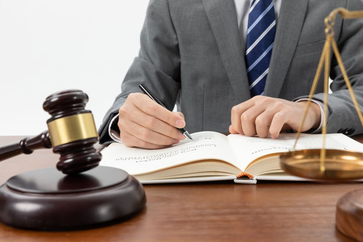 Business lawyer meeting with clients to discuss legal documents in an office